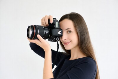 Woman holding camera to eye