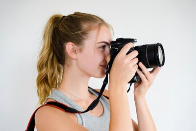 Blonde girl photographing with camera