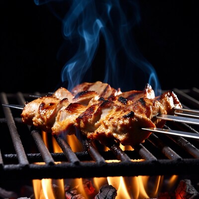 Chicken skewers grilling on barbecue