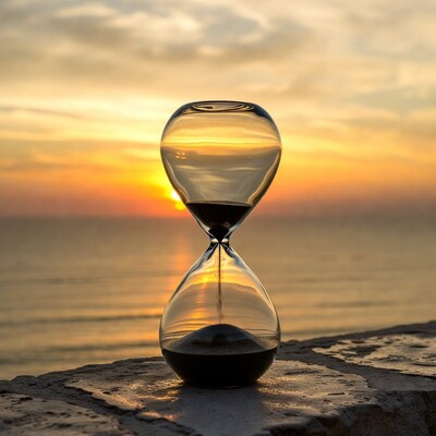 Hourglass at sunset over sea