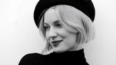 Blonde woman in beret smiling
