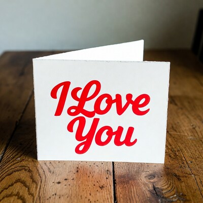 I Love You card on wooden table