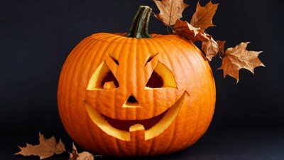Jack-o-lantern with fall leaves