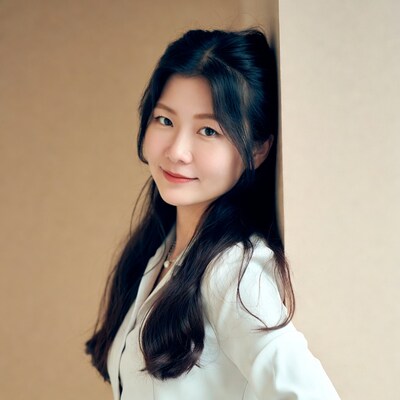 Asian woman leaning against wall