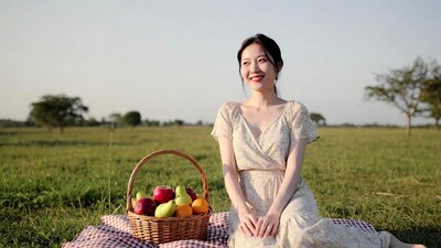 Asian woman with fruit basket on picnic