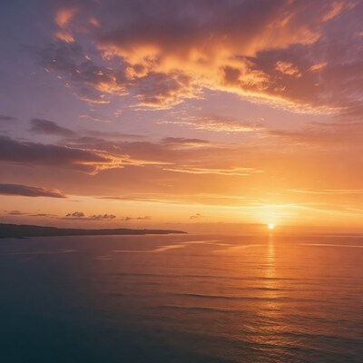 Sunset over ocean with clouds