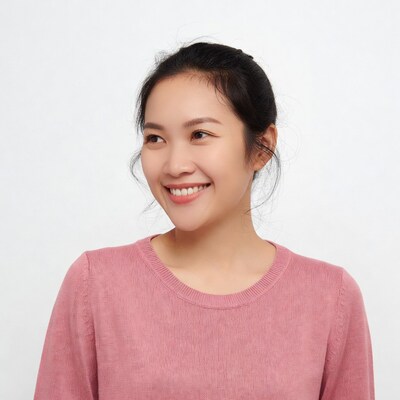 Asian woman smiling in pink sweater