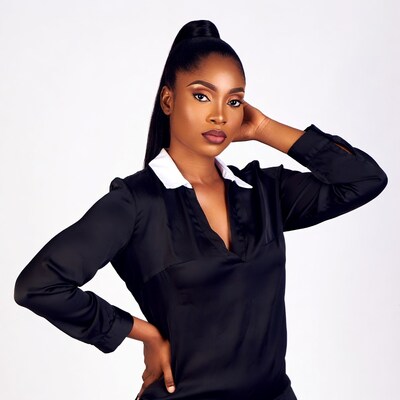 African woman in black blouse ponytail