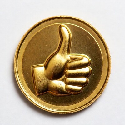 Gold thumbs up coin