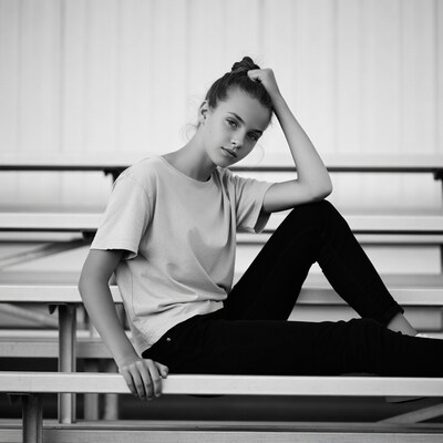 Teen girl sitting on bleachers