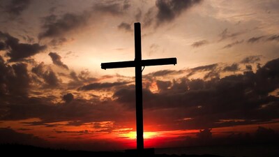 Silhouette cross at sunset