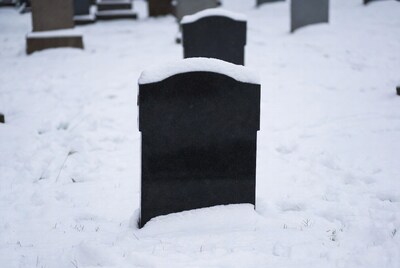 Snowy Black Gravestone in Cemetery