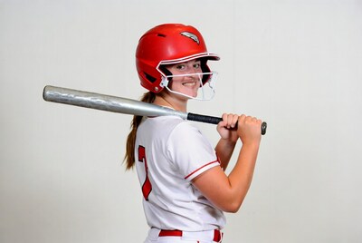 Girl in red softball helmet holding bat