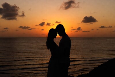 Silhouette couple embracing at sunset beach