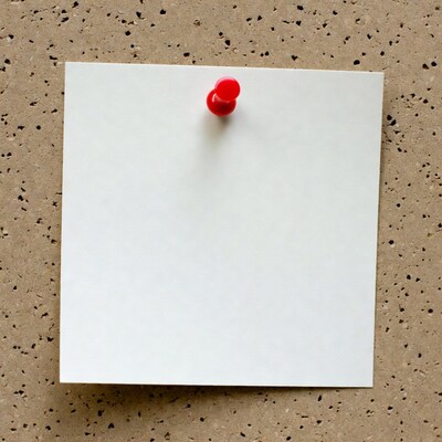 Blank note pinned to corkboard