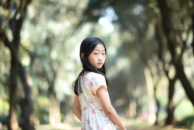 Asian girl in floral dress in forest