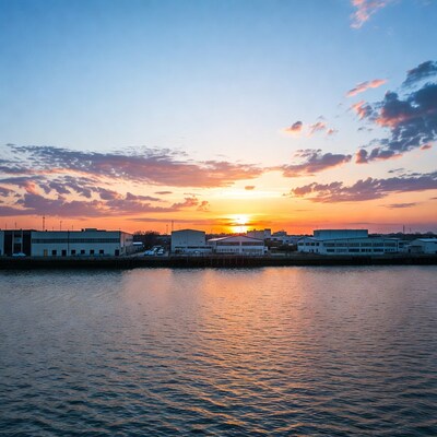 Sunset over industrial harbor buildings