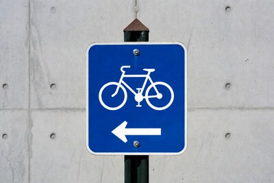 Blue bicycle lane sign pointing left