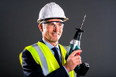 Man in suit holding drill