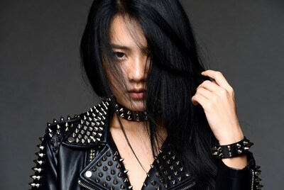 Asian woman in spiked leather jacket