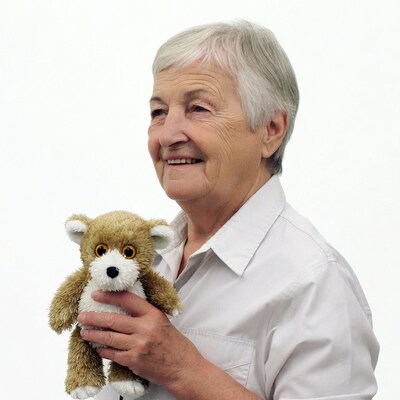 Elderly woman holding teddy bear