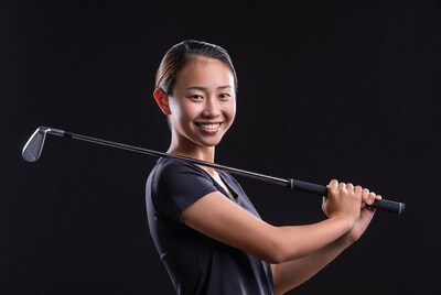 Asian woman holding golf club