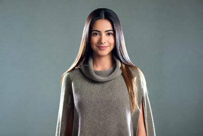 Smiling Latina woman in gray turtleneck