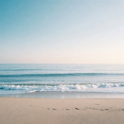 Ocean waves crashing on sandy beach
