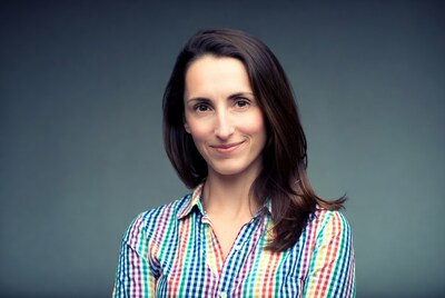 Woman smiling in colorful plaid shirt