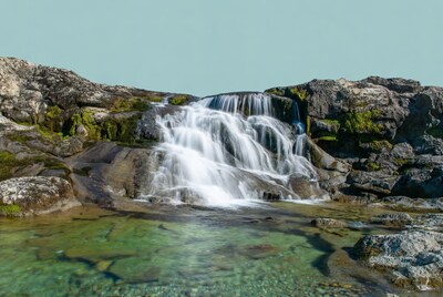 Waterfall cascading over mossy rocks