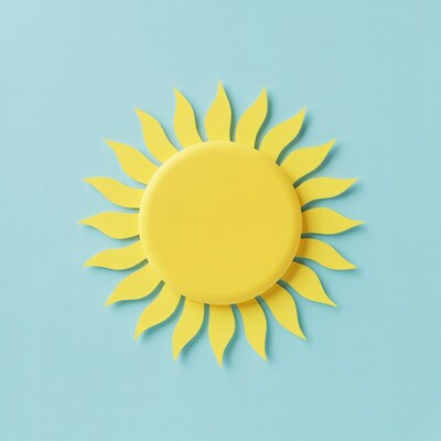 Yellow paper sun on blue background