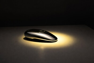 Shiny metallic oval device on table
