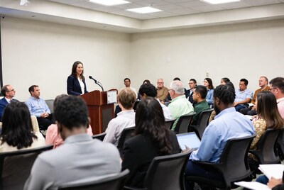 Woman speaking at business meeting podium