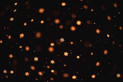 Golden snowflakes on black bokeh background