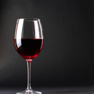 Red wine glass on black background
