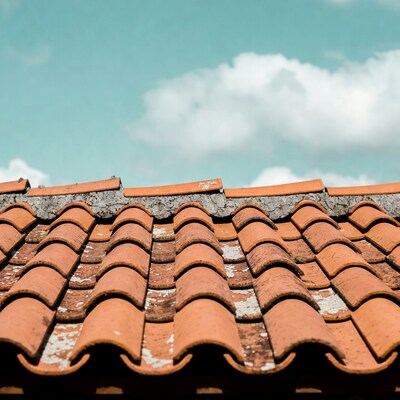 Red terracotta roof tiles under blue sky