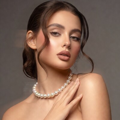 Woman touching pearl necklace