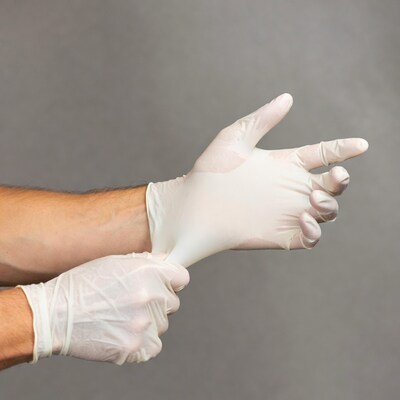 Hands putting on latex gloves