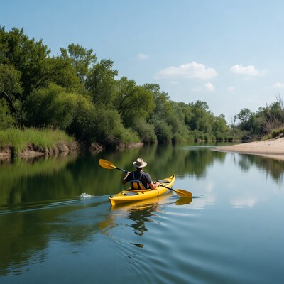 Man kayaking on calm river