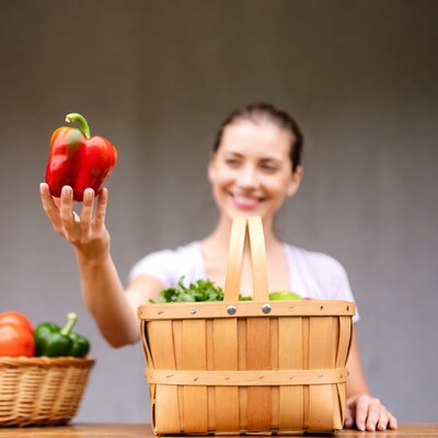 Woman holding red bell pepper