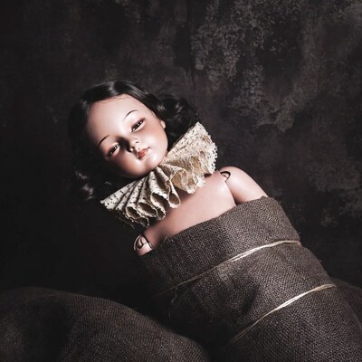 Vintage doll with lace collar