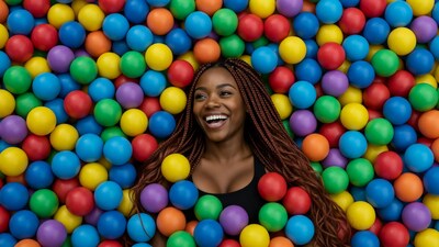 Woman smiling in colorful ball pit