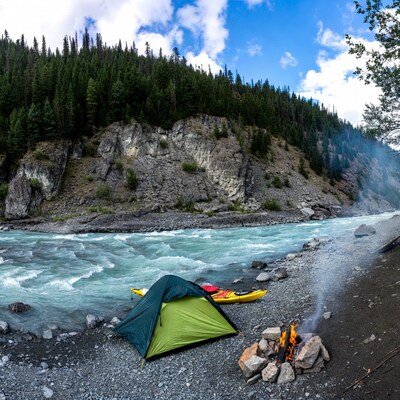 Camping by river with kayak