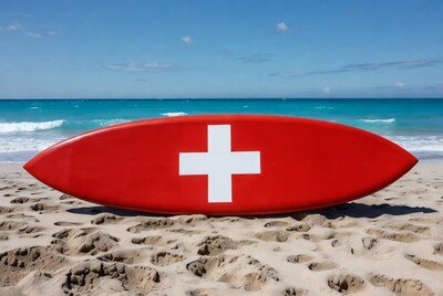 Red surfboard with Swiss flag on beach