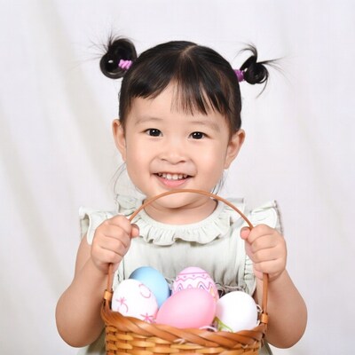 Asian girl holding Easter egg basket