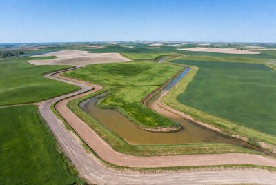 Aerial view of winding river in farmland
