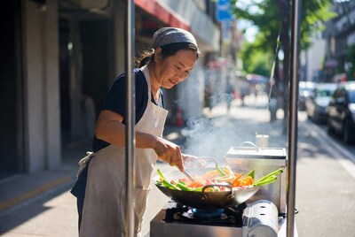 Asian woman cooking stir fry
