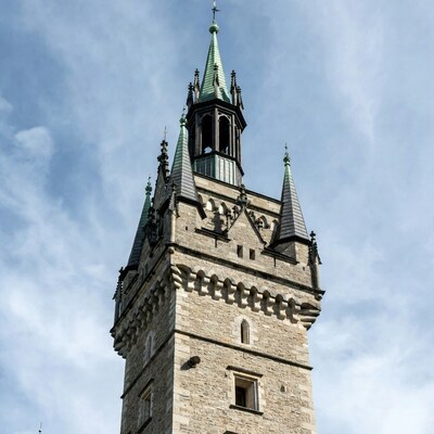 Gothic stone tower with green spire