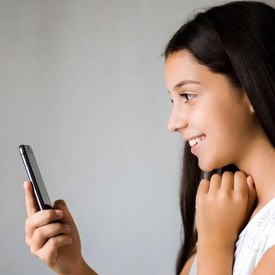 Girl smiling while holding smartphone