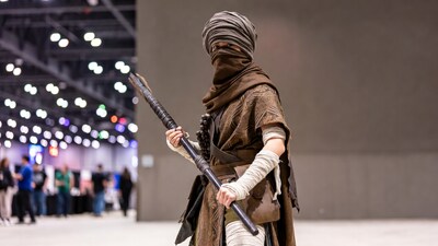Woman in costume holding staff